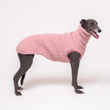 Greyhound dog wearing Snootly fluffy reversible sleeveless sweater in marshmallow pink on white background