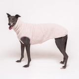 Greyhound dog wearing Snootly fluffy reversible sleeveless sweater in vanilla on white background