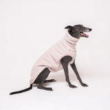 Greyhound dog wearing Snootly fluffy reversible sleeveless sweater in vanilla on white background
