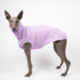 Whippet dog wearing a fluffy reversible sleeveless sweater/jumper in lilac/purple colour left side